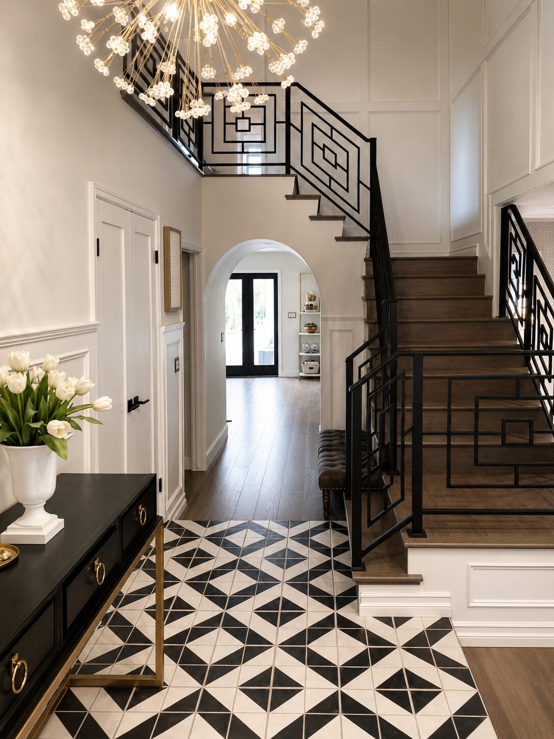 Photoreal render of a contemporary Spanish-influenced entryway with geometric tile and brass chandelier